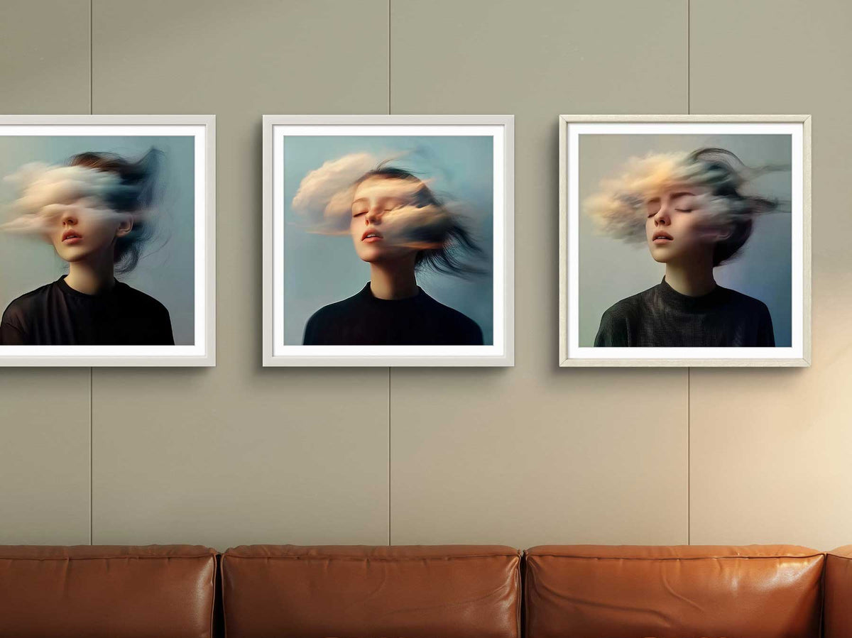 Three framed photographic portraits hung above a leather sofa in a living room