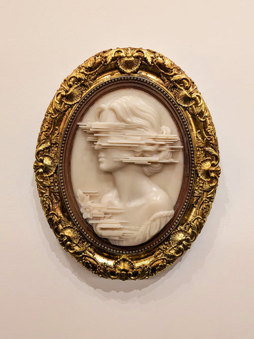 Anne Brontë Cameo — resin and 24k gold leaf by JoCa: an ivory cameo profile whose face breaks into horizontal glitch layers, in an ornate gold oval frame